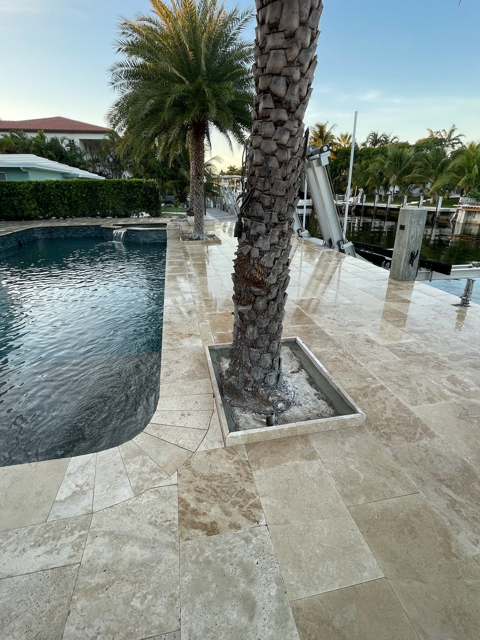 Waterfront travertine pool deck installation South Florida