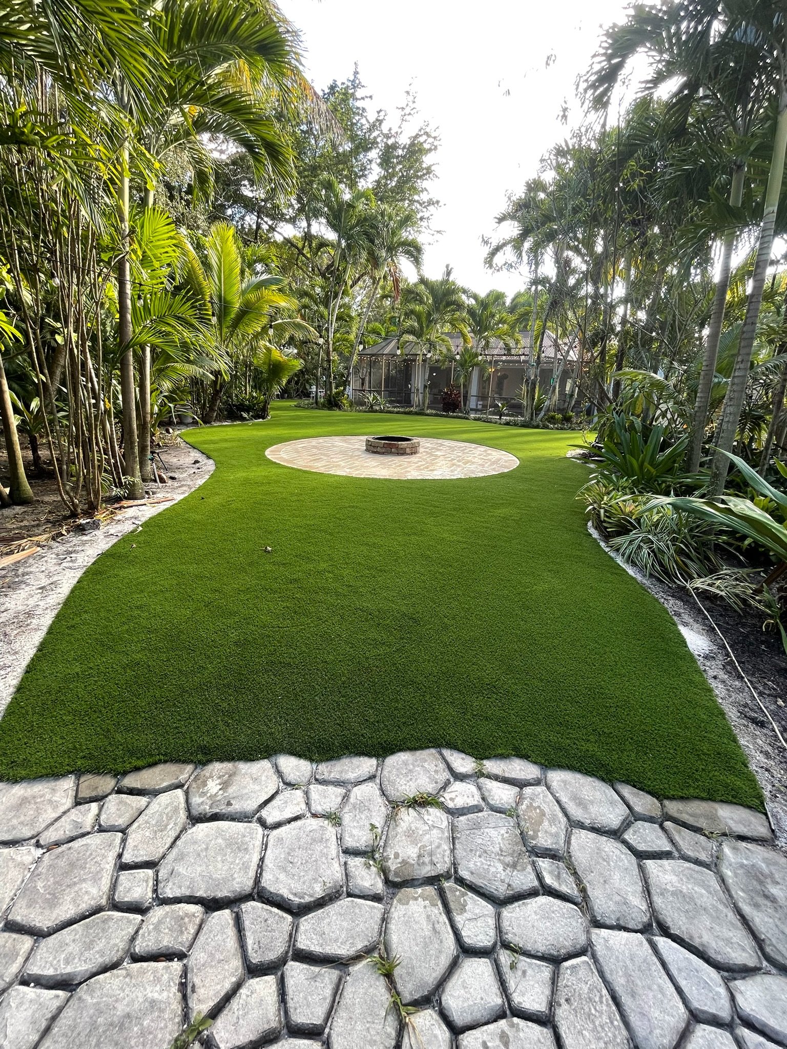 Synthetic turf and paver combination backyard South Florida