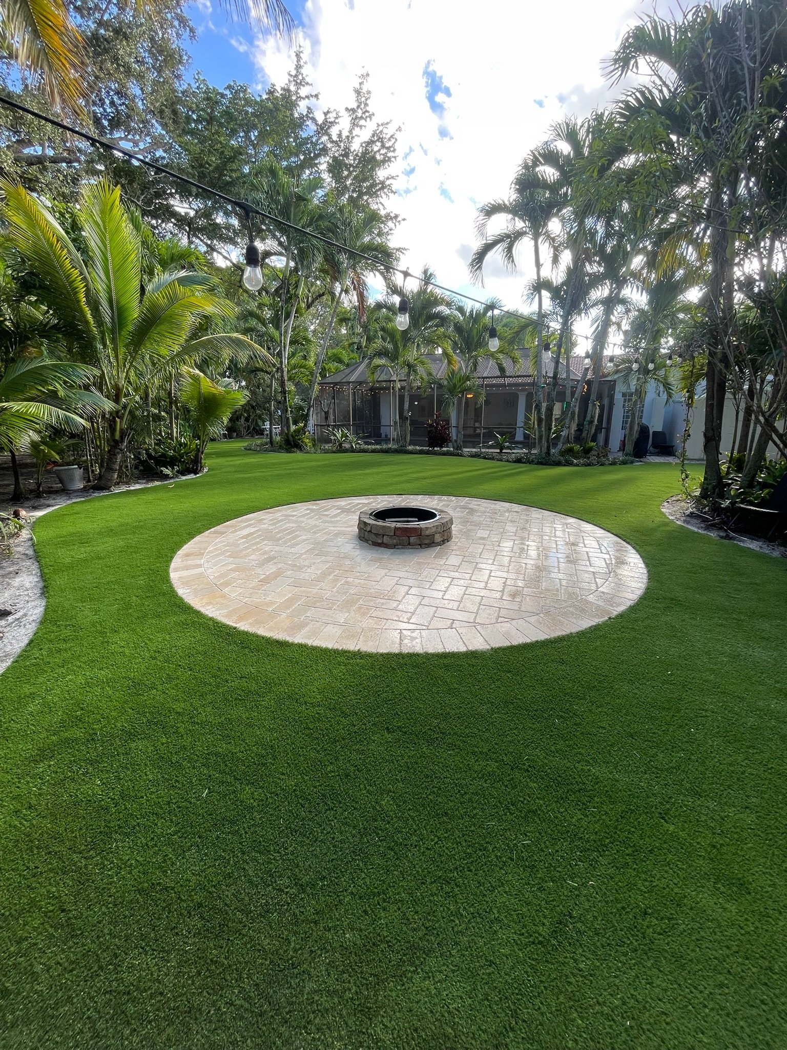 Artificial turf installation with paver fire pit South Florida